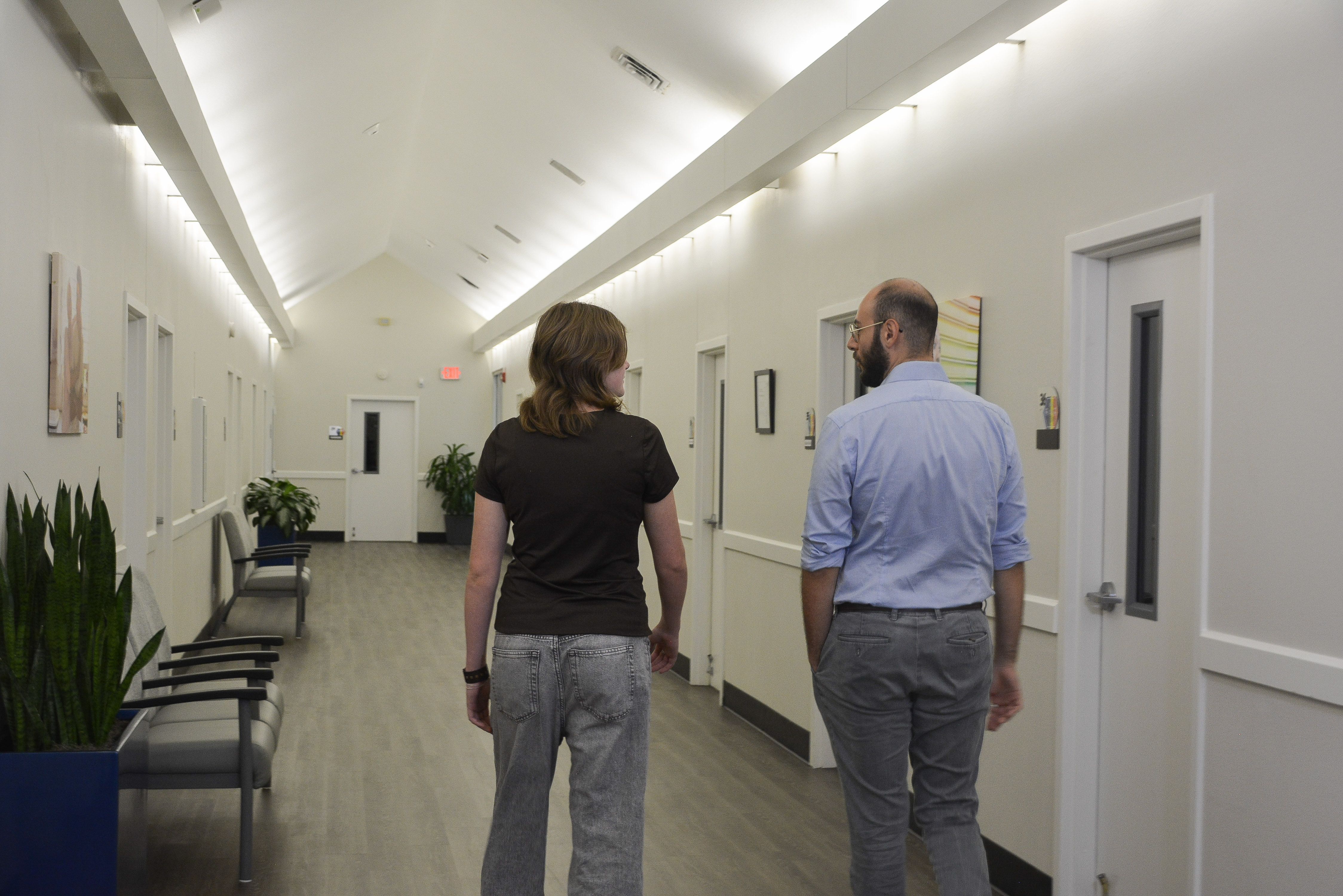 Clinician walking through hallway with client
