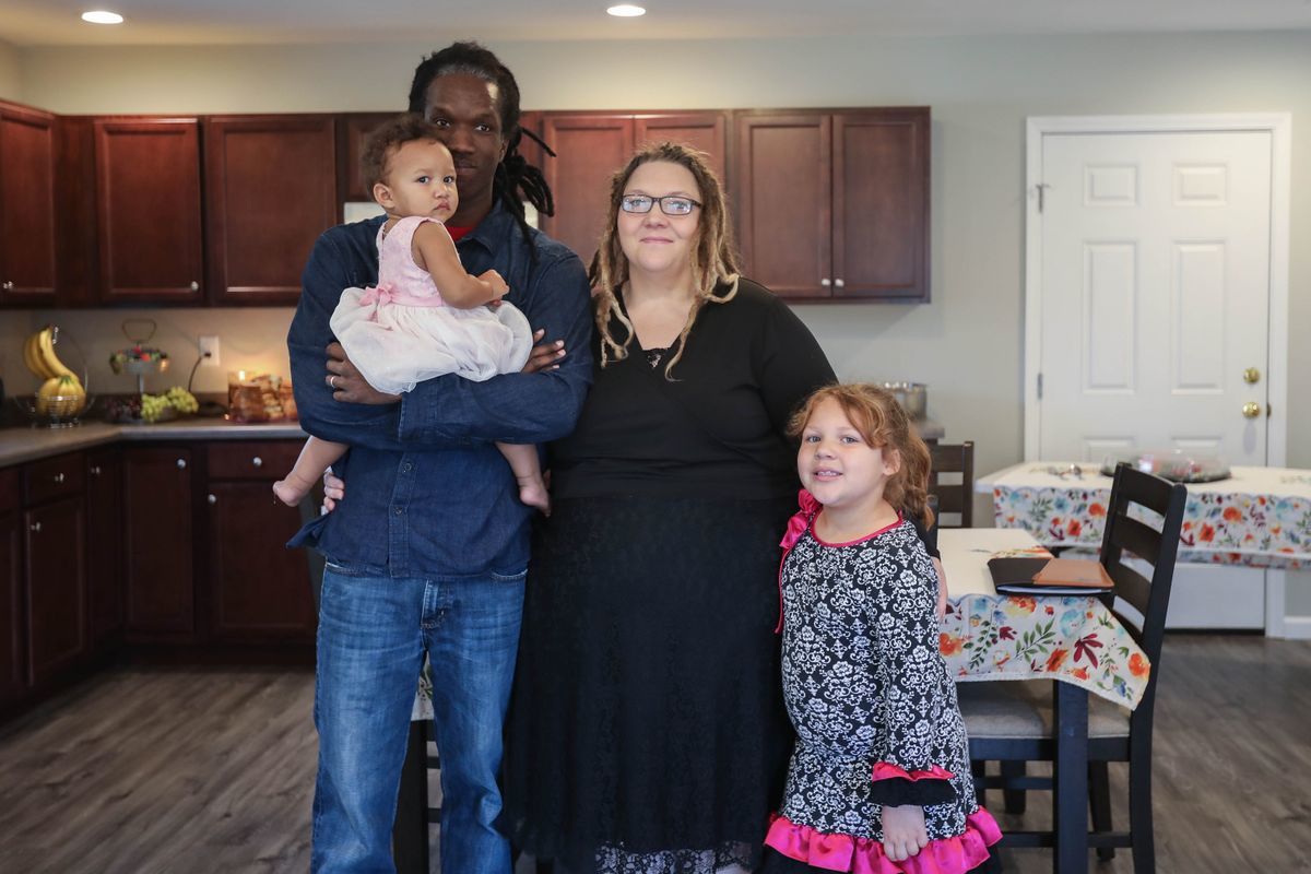 Tabitha and her family, the homeowners of the Athletics Build, stand posed together in their new kitchen. 