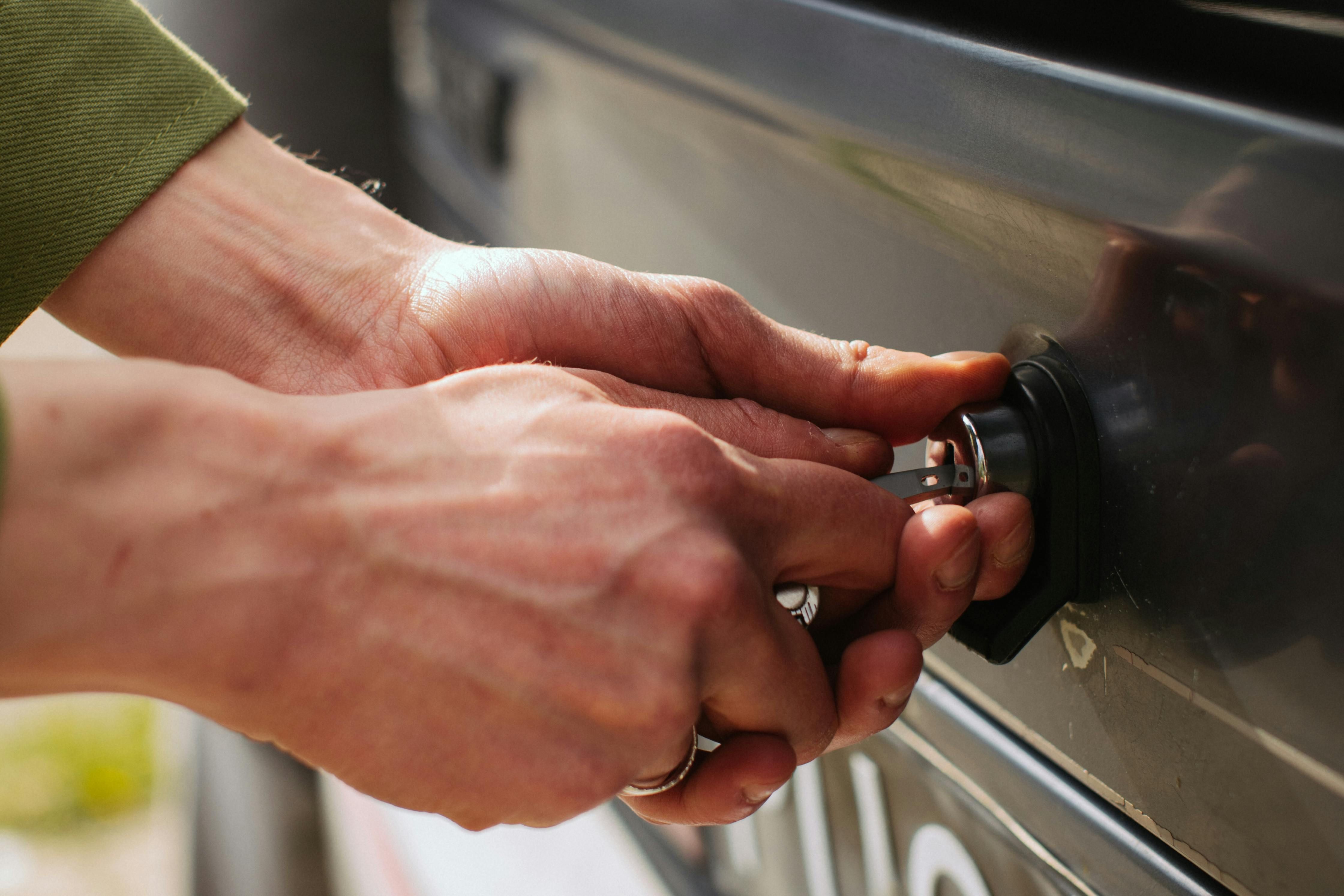 A person is locking a metal cabinet 