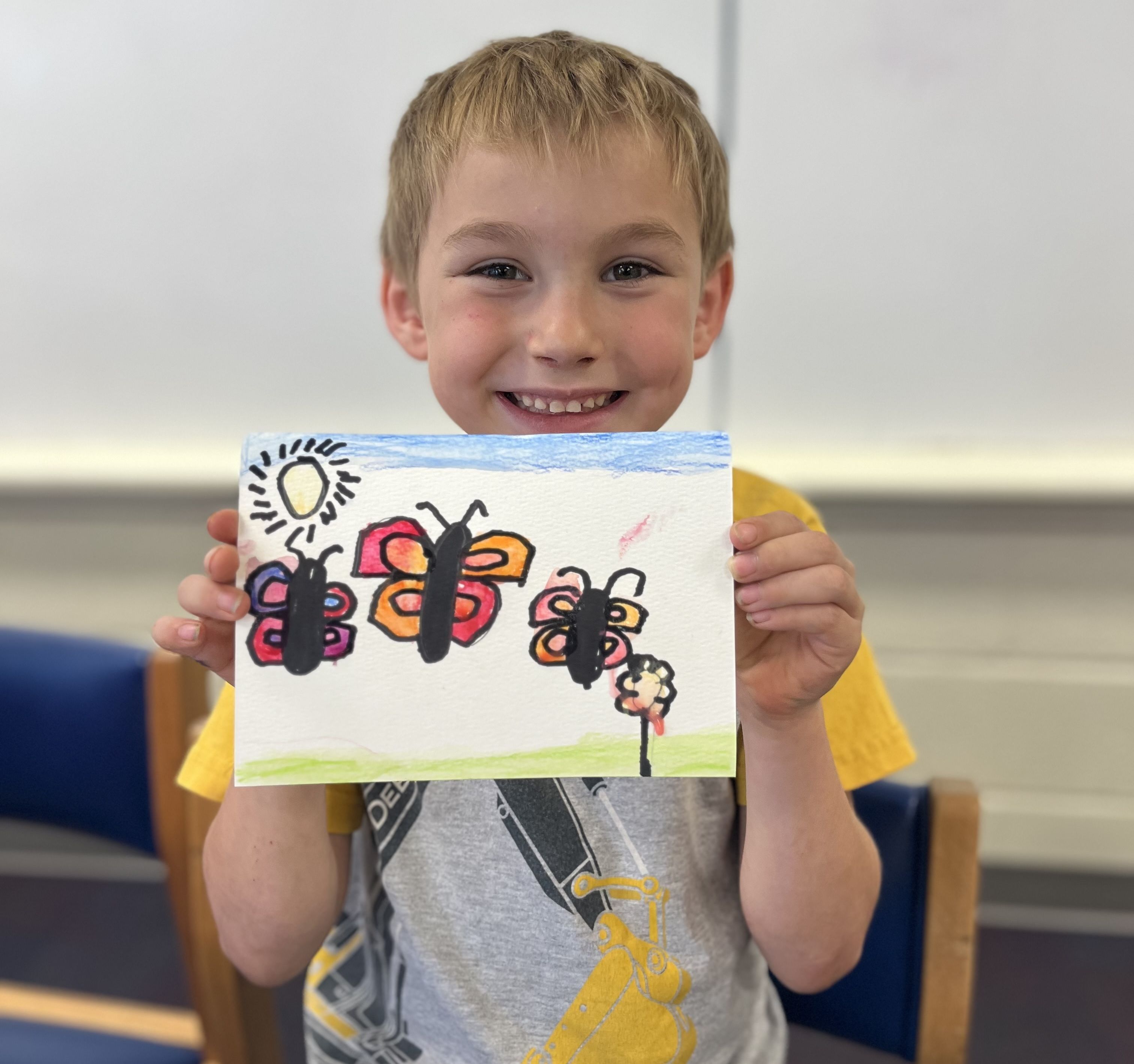 Happy student using their wildlife journal from the 'Nature in Your Backyard' program