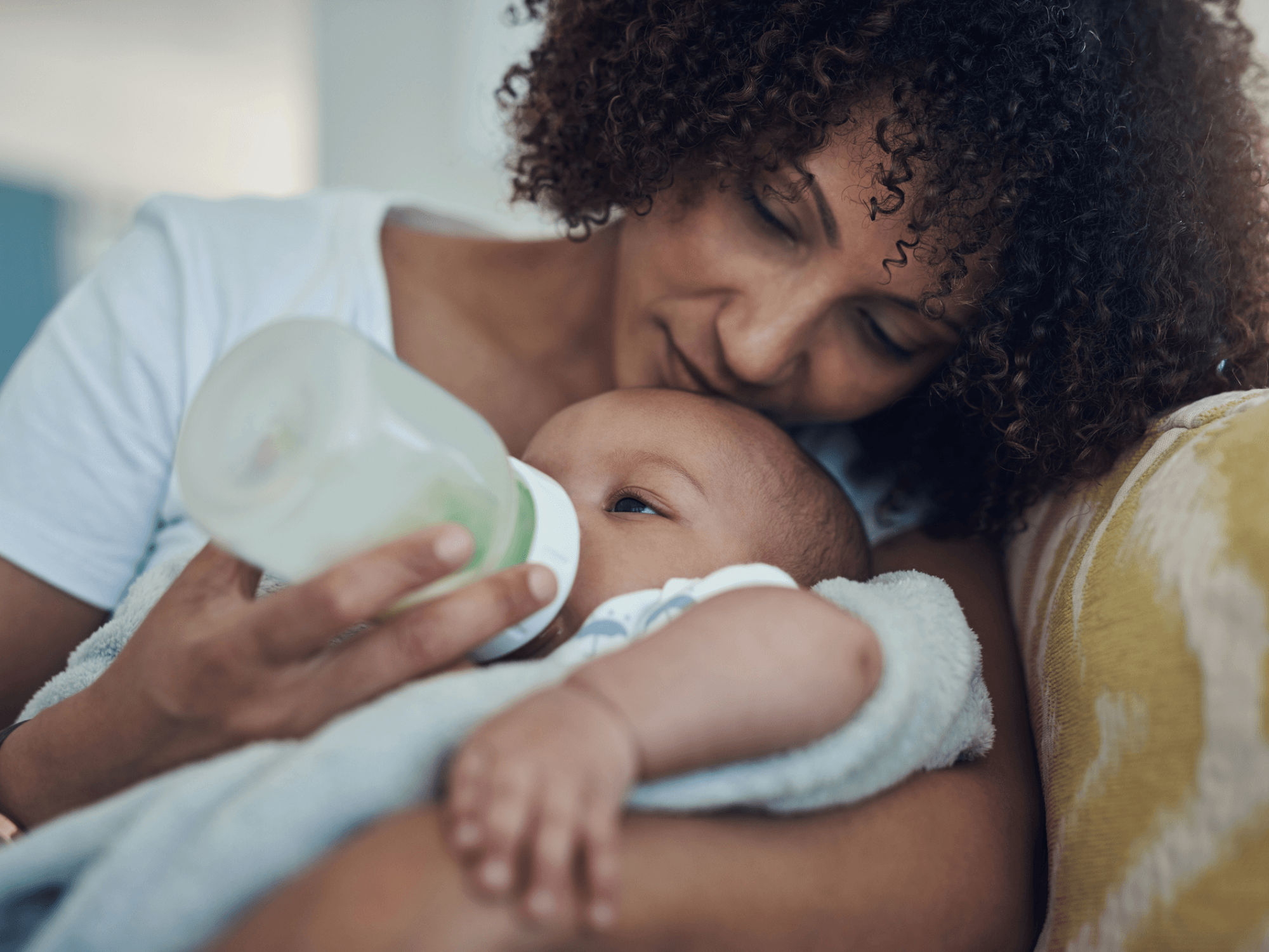 Mother feeding baby a bottle. 