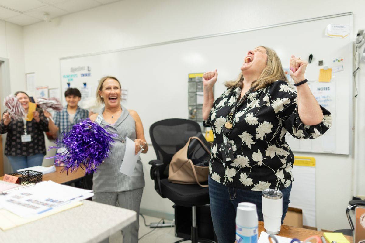 teacher leaps with excitement after being awarded a grant