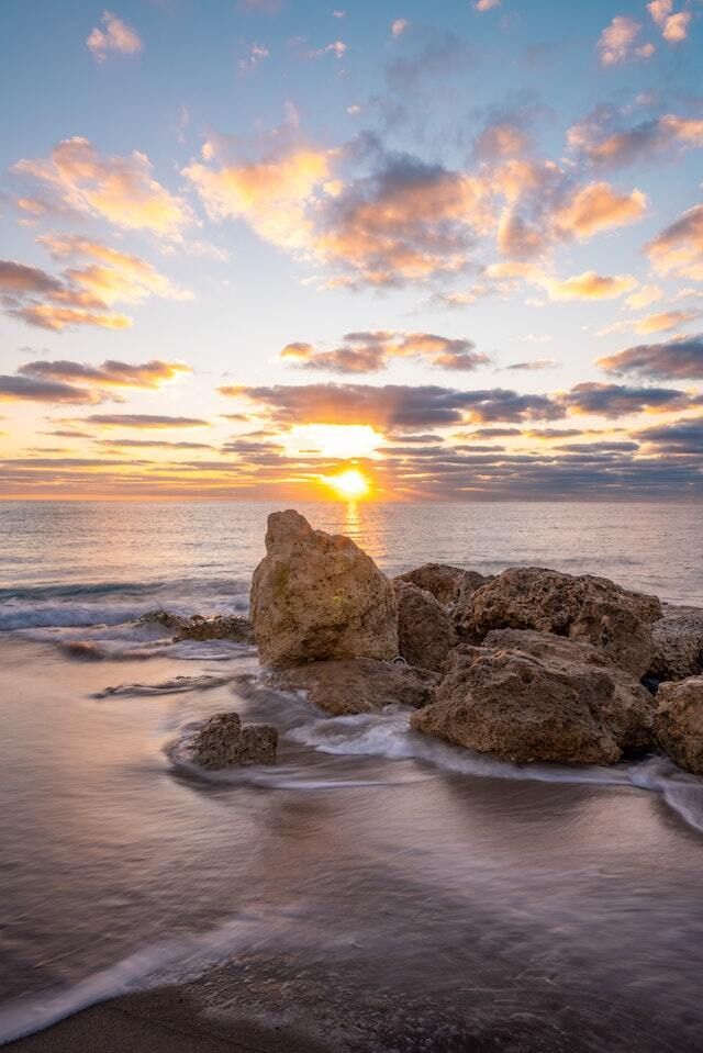 sunrise over water and rocks