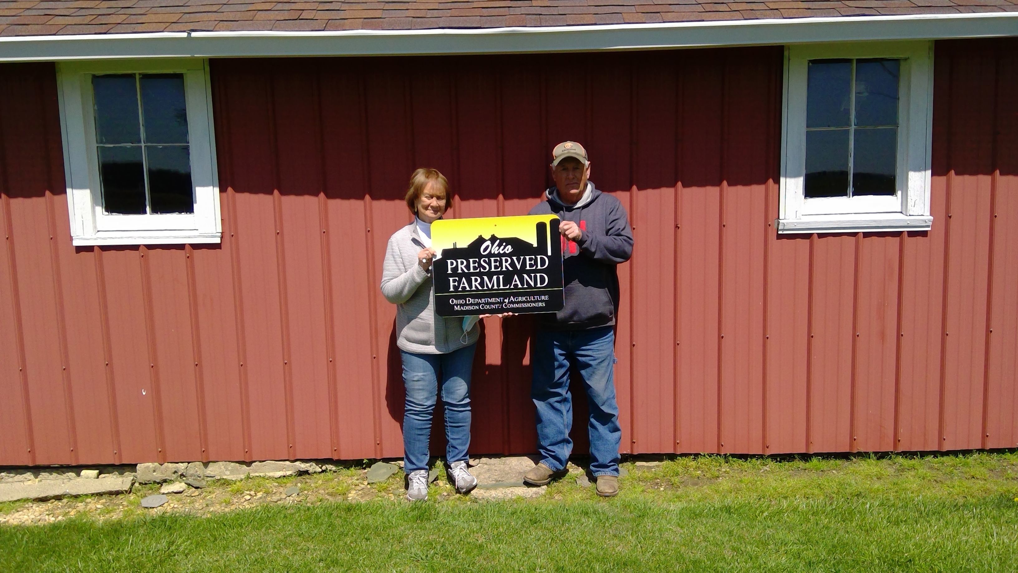 couple holding farmland preservation sign