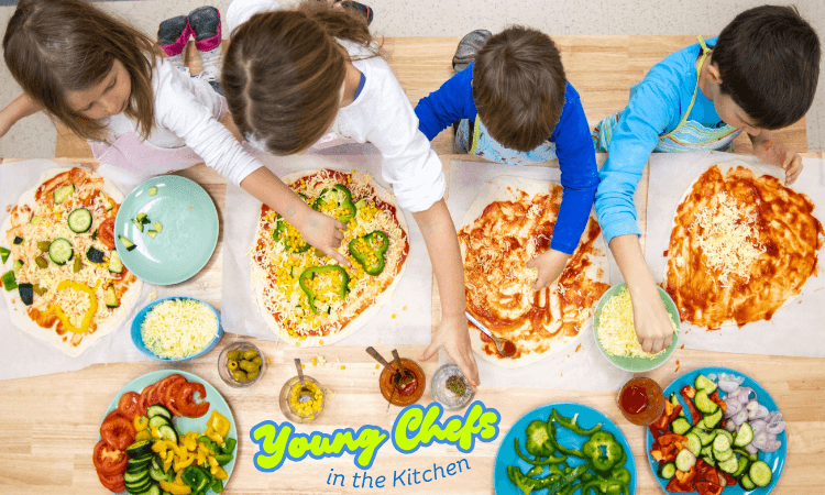 Four children making pizza together.