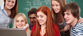 Group of students looking at a computer.