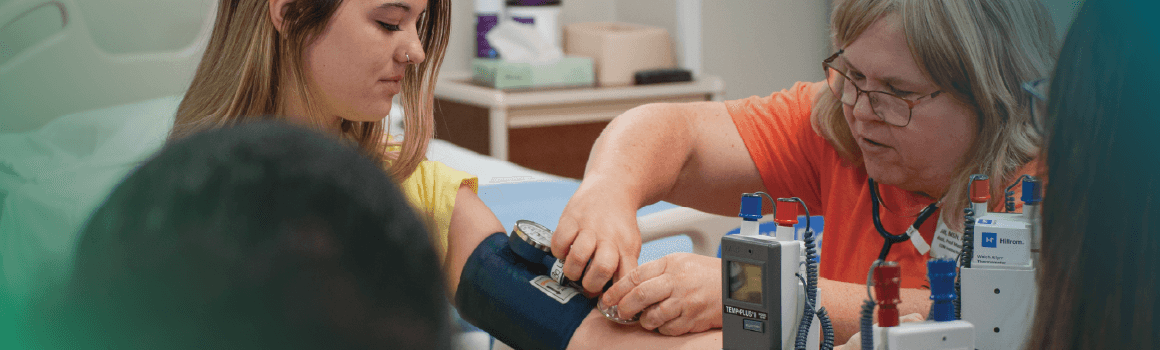 nursing facutly demonstrating blood pressure