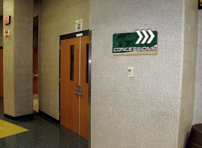 School hallway with concession sign arrow helping with school navigation, custom signs