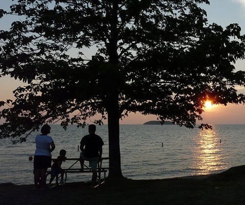 A family enjoying the sunset on Lake Erie.