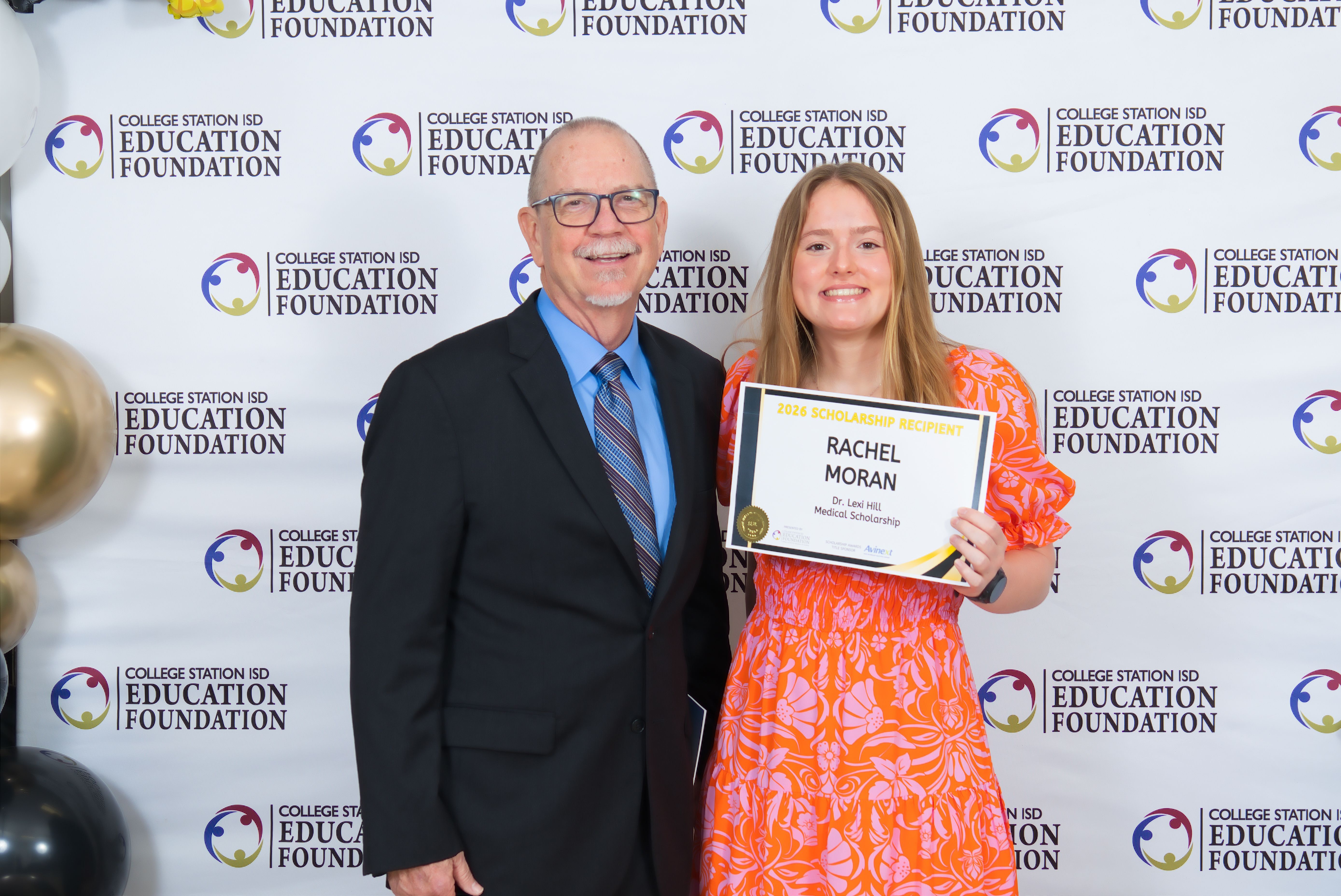 Scholarship donor and recipient pose for a photo