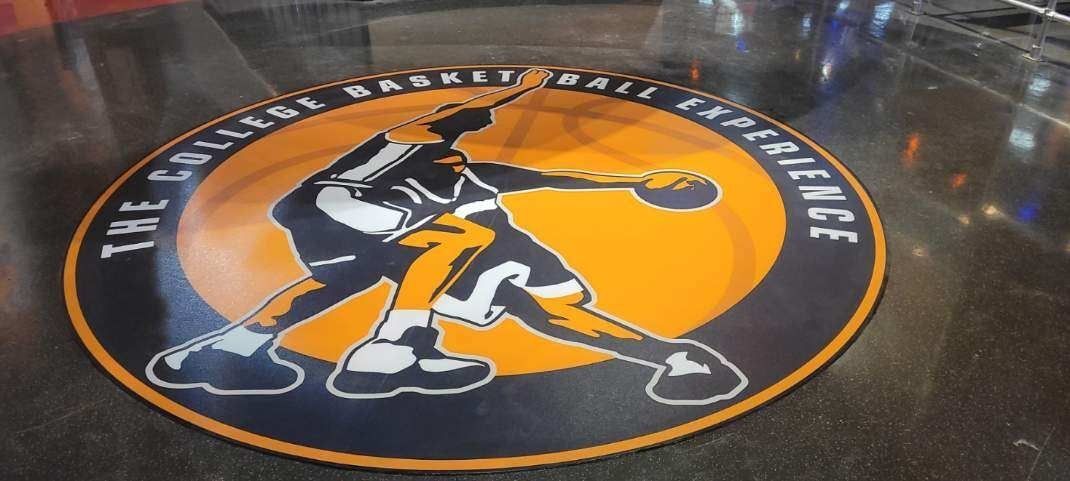 Floor graphic in orange and black of basketball player with basketball