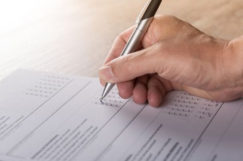 image of hand with pen and paper