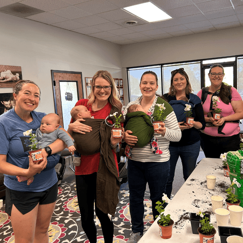 Group of women with babies sitting on the floor