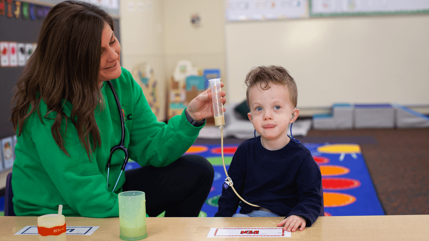 Nurse assisting with a feeding