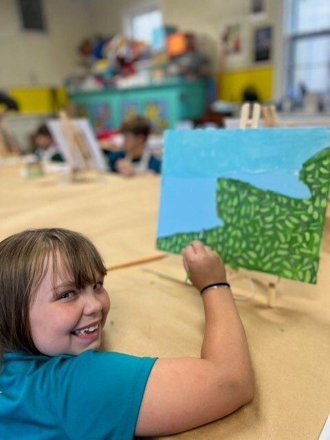 child painting landscape scene