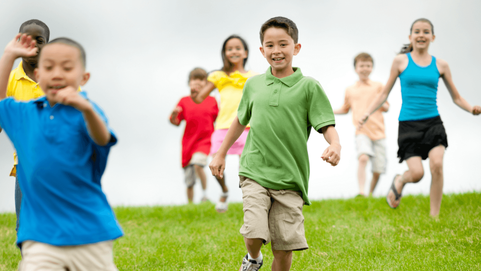 Happy children running through a field