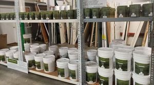 Shelves stocked with GreenSheen recycled latex paint at Habitat ReStore Zephyrhills – eco-friendly interior and exterior paint in quart and 5-gallon sizes