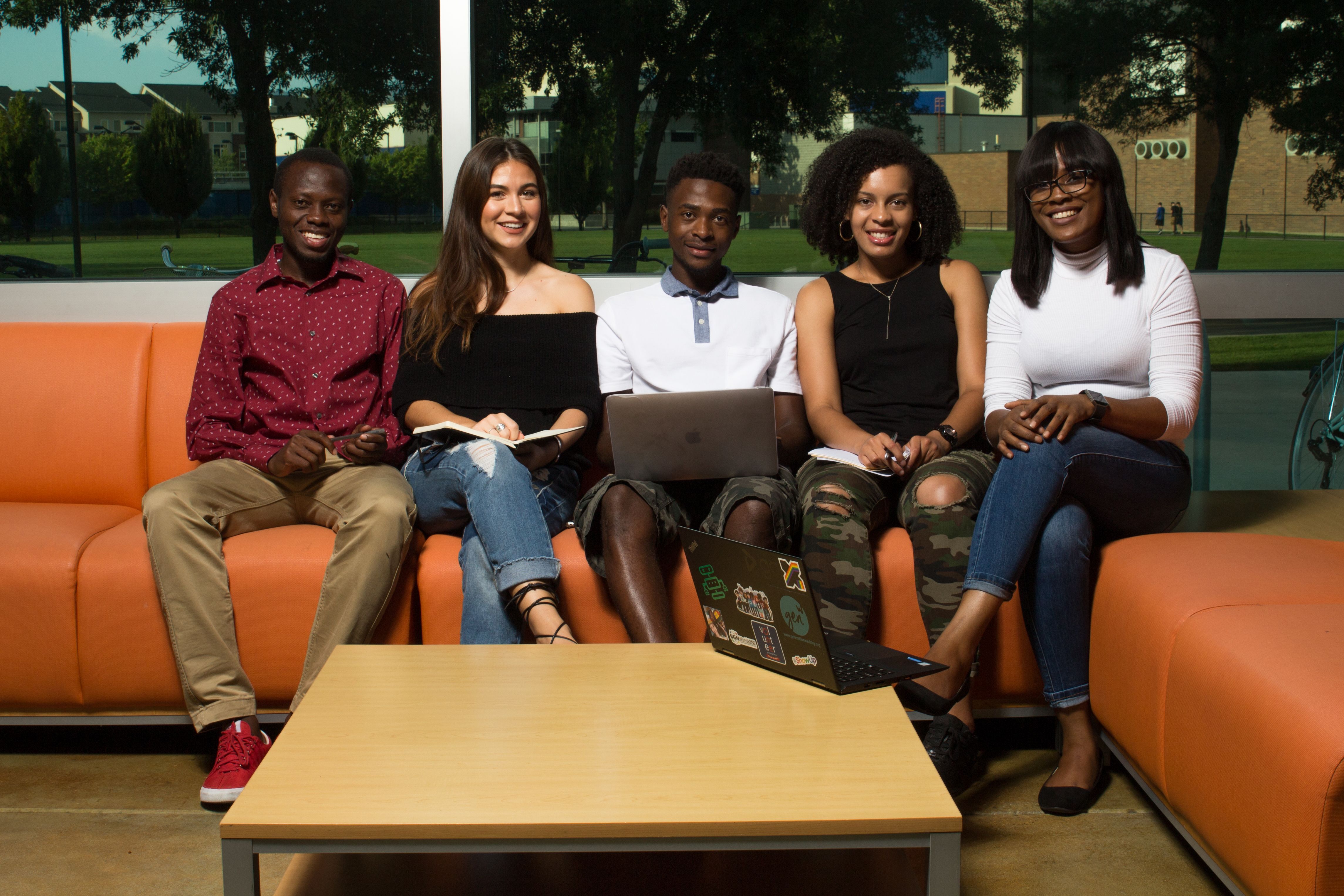 Students sitting together with a laptop.