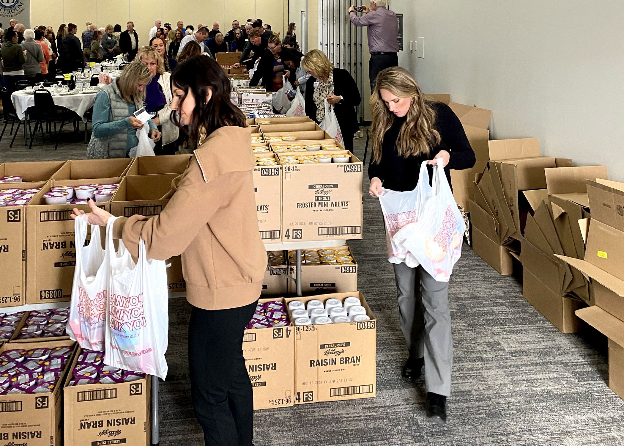 Luncheon Attendees Pack Food Bags for Backpack Attack Program