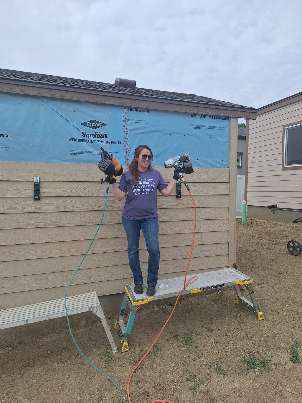 Women's Build: volunteer using staple gun