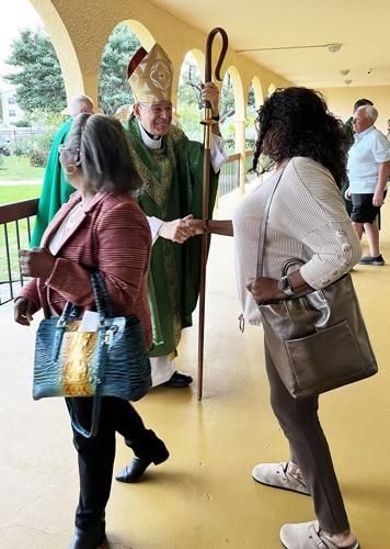 Bishop Barbarito greets well-wishers after the Black Cultural Awareness Mass at St. Francis of Assisi Church