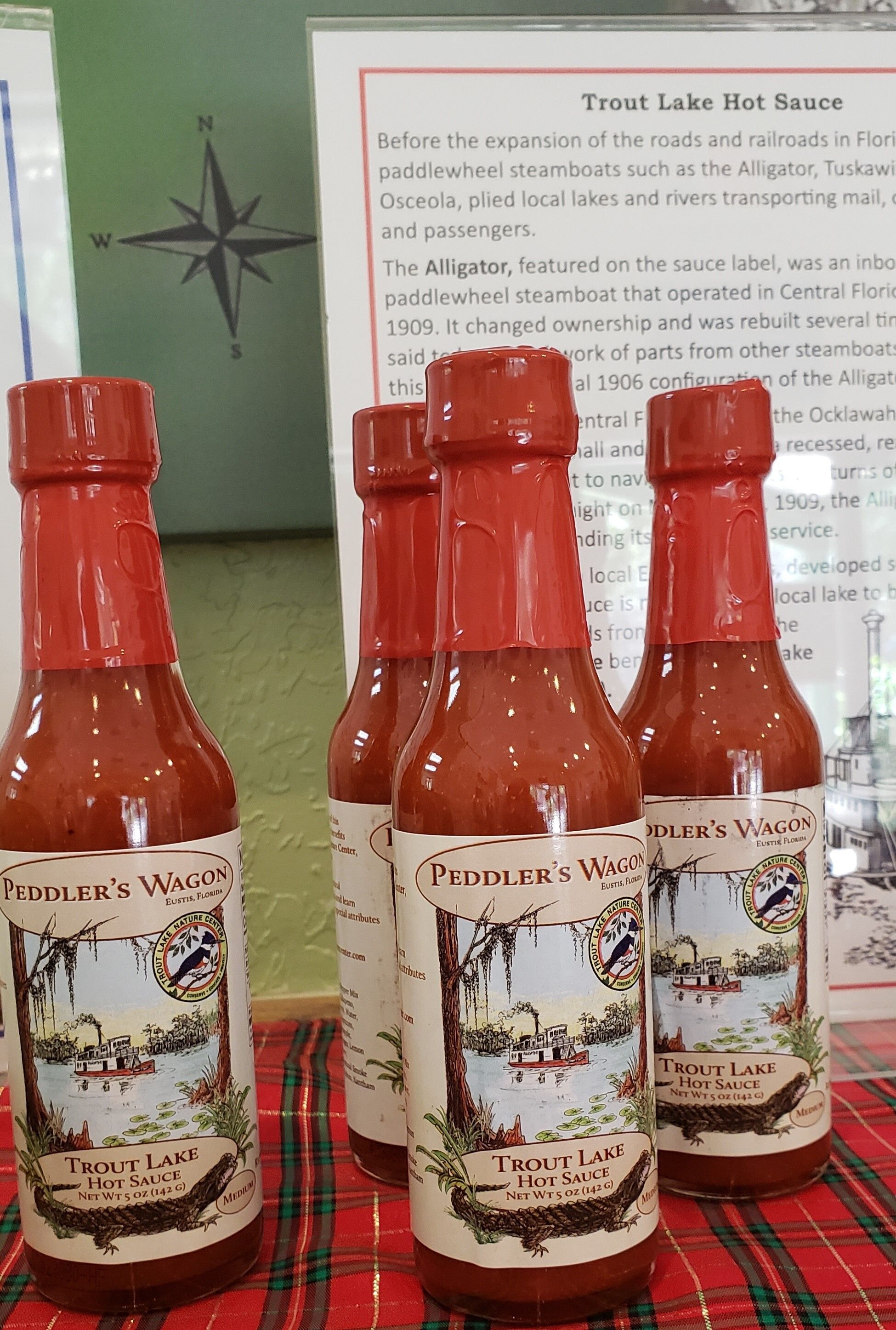 four hot sauce bottles are shown