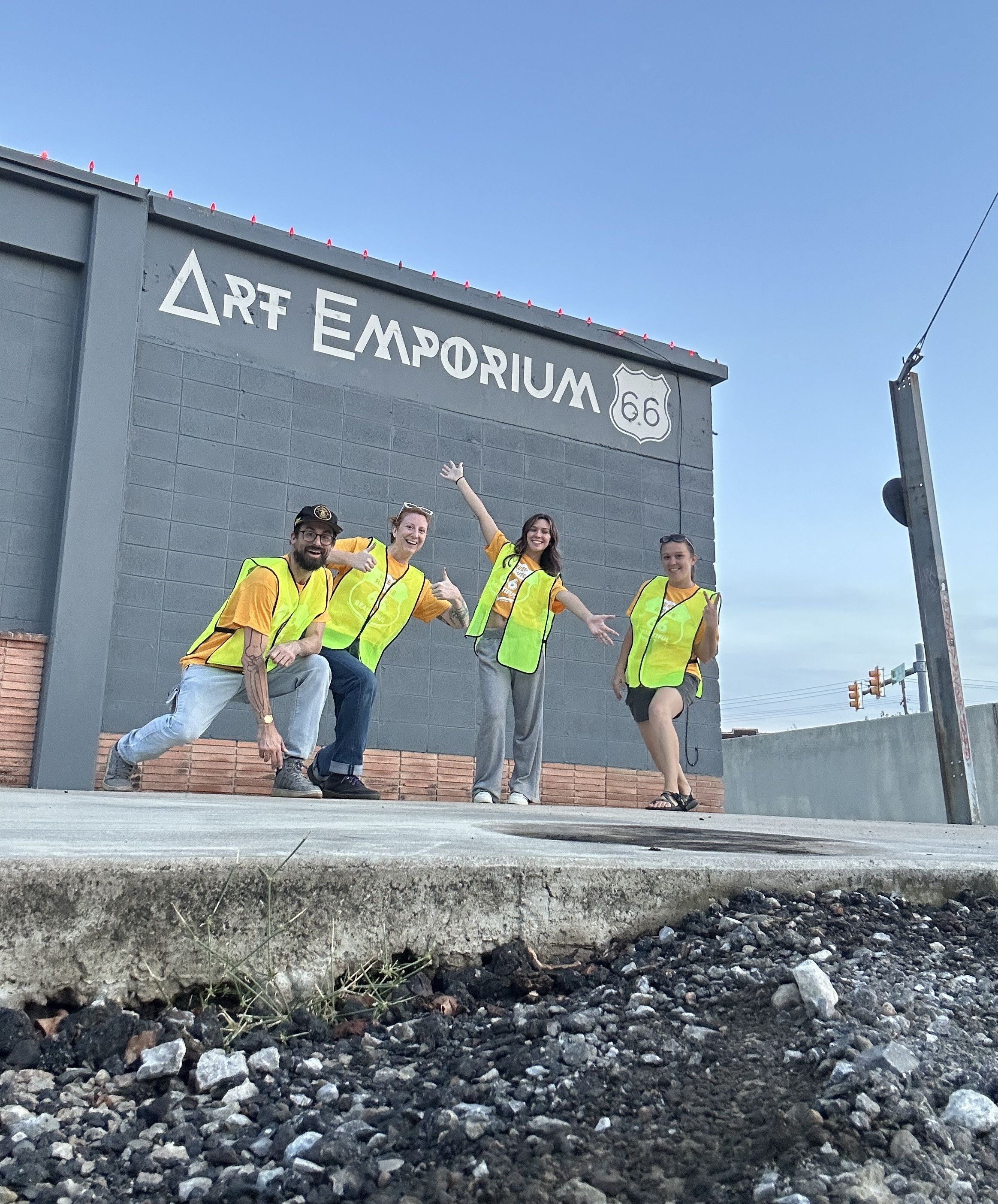 Four people in safety vests posing for a silly picture