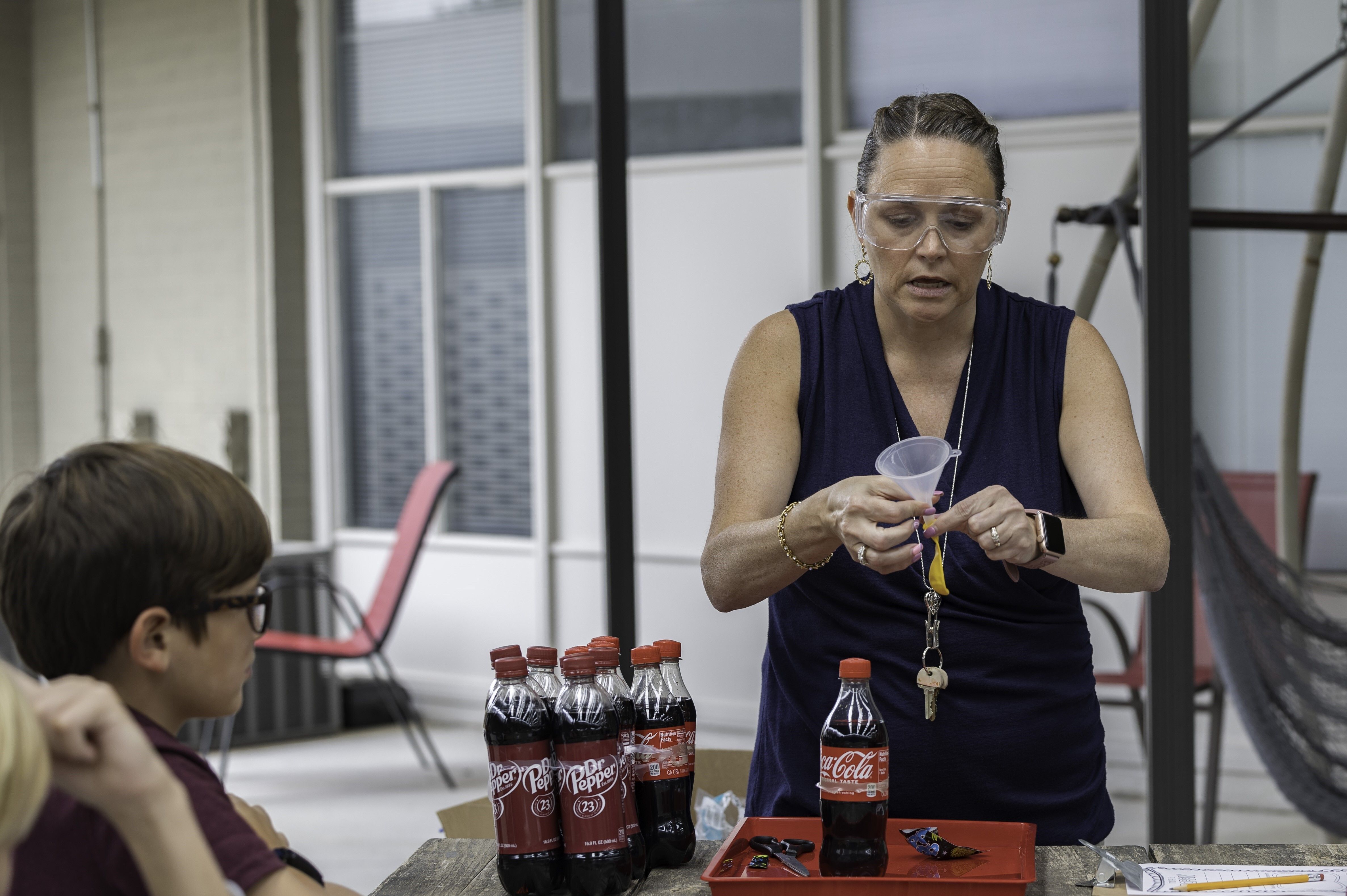 Teacher demonstrating a science experiment to students 