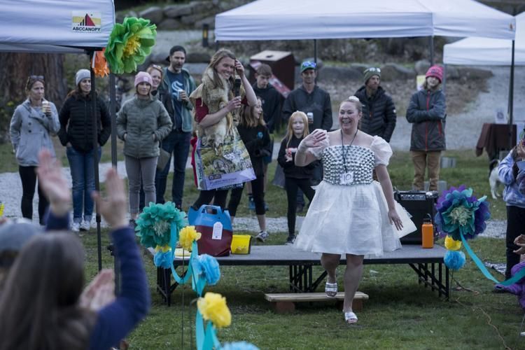 A photo of a woman walking down the runway in her dress made of bubble wrap.
