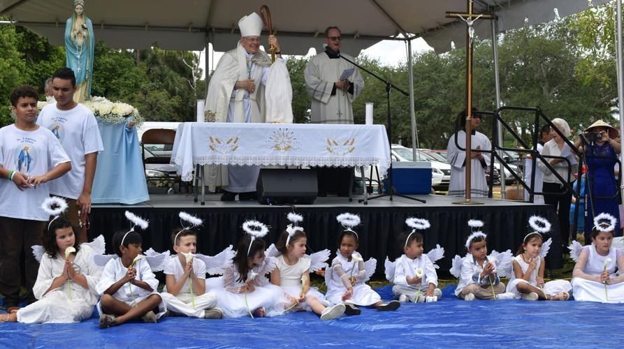 Bishop Gerald M. Barbarito watches a procession honoring Mary with children dressed as angels at the International Marian Festival May 4, 2025, at Emmanuel Parish in Delray Beach.
