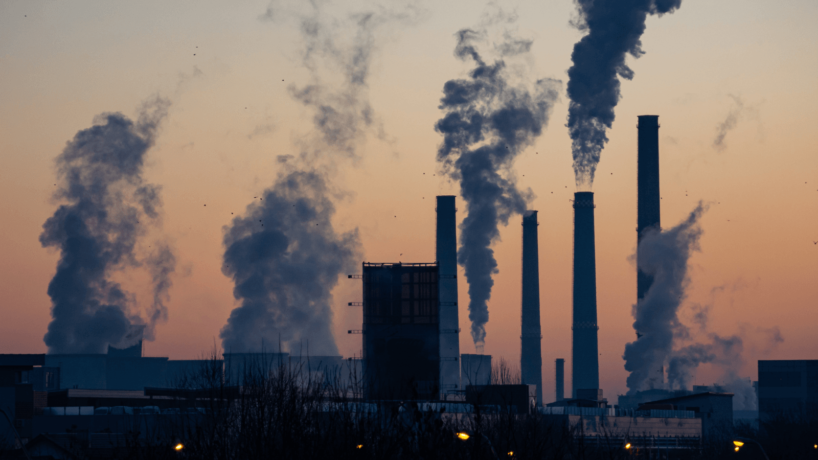Active power plant releasing emissions at dusk