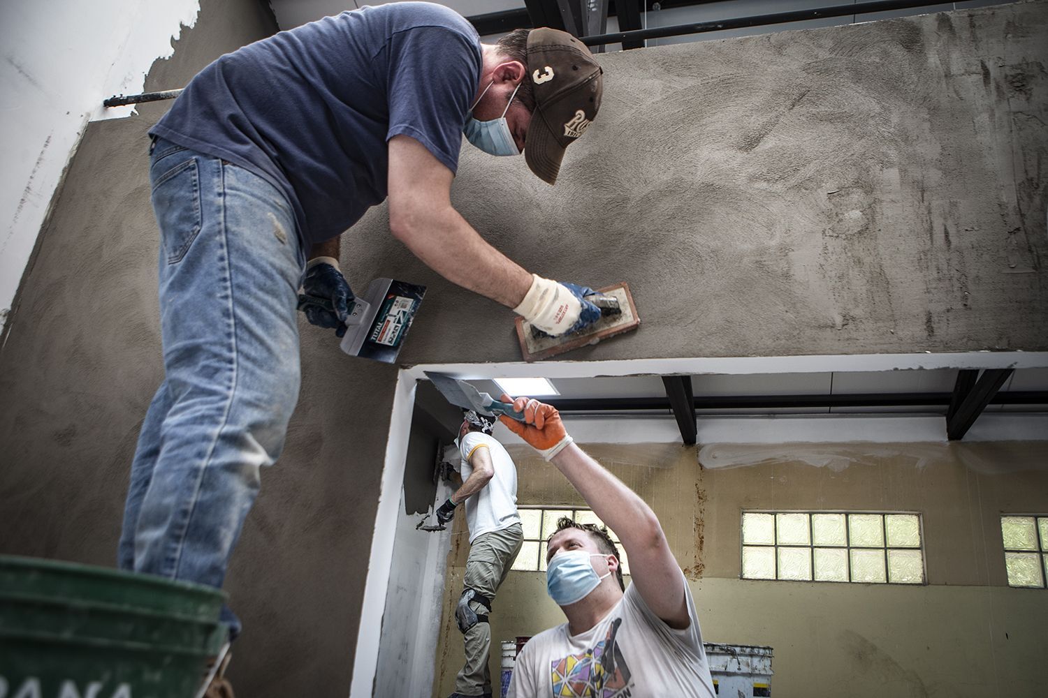 The team members work to finish the kitchen and dining room area at the River House