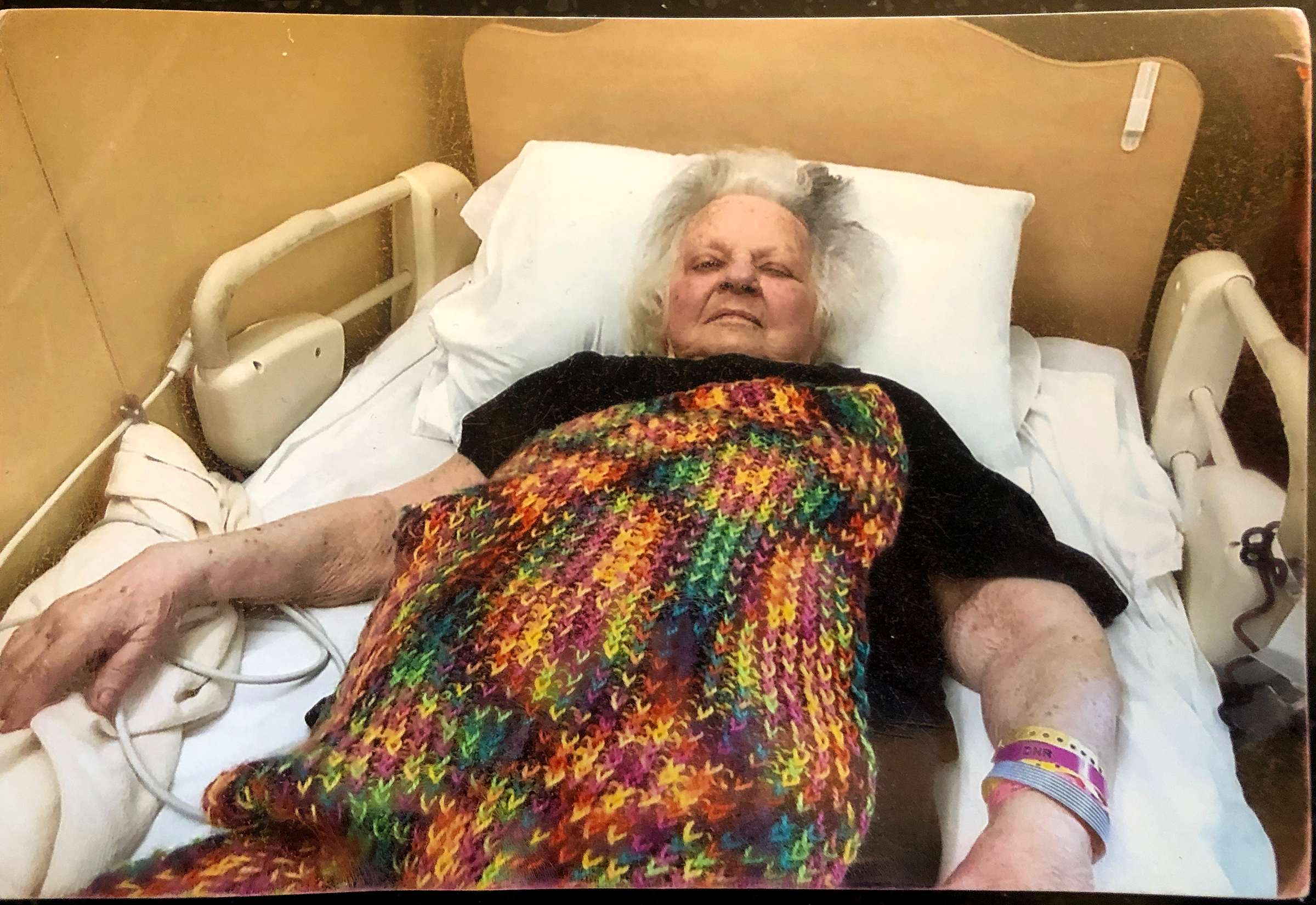 Diane's mother Charlotte with the blanket Diane knitted as a gift.