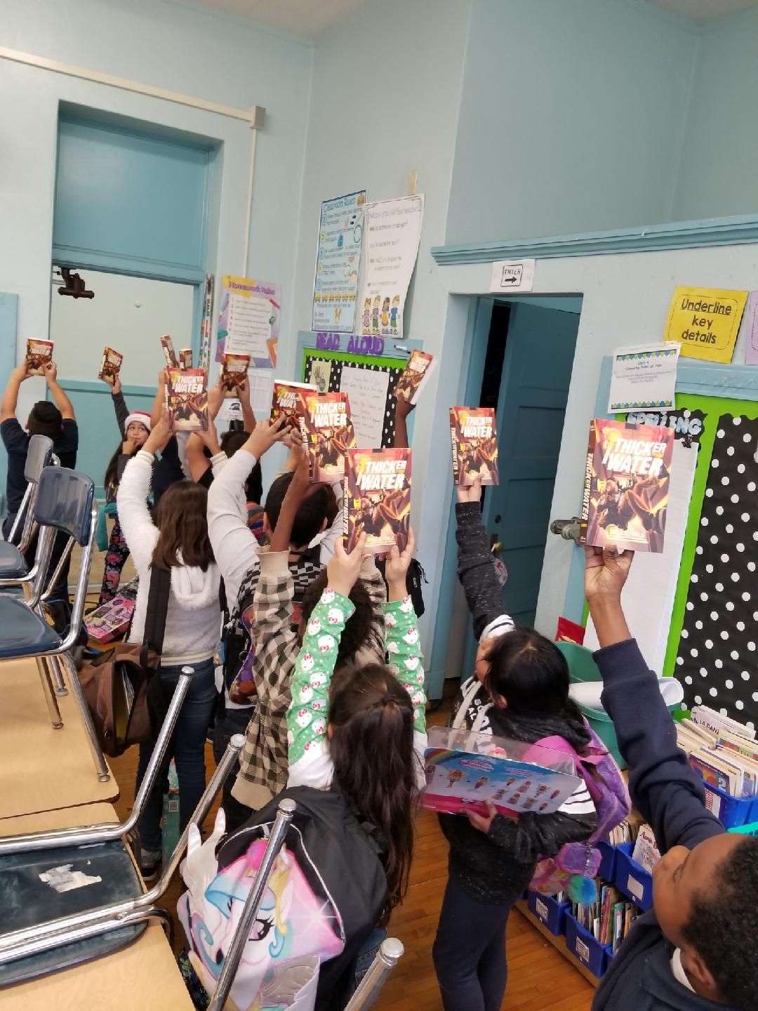 Kids with books in the air.