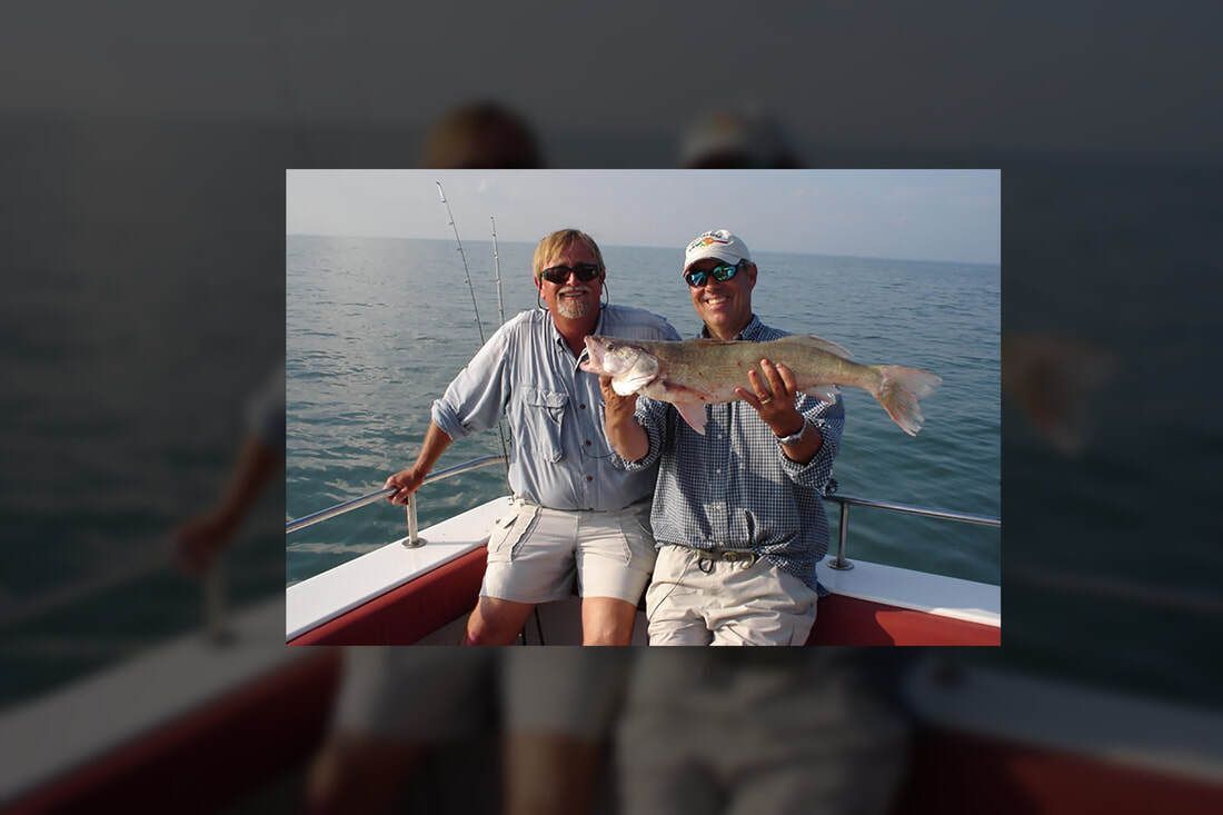 Two men with a fish.