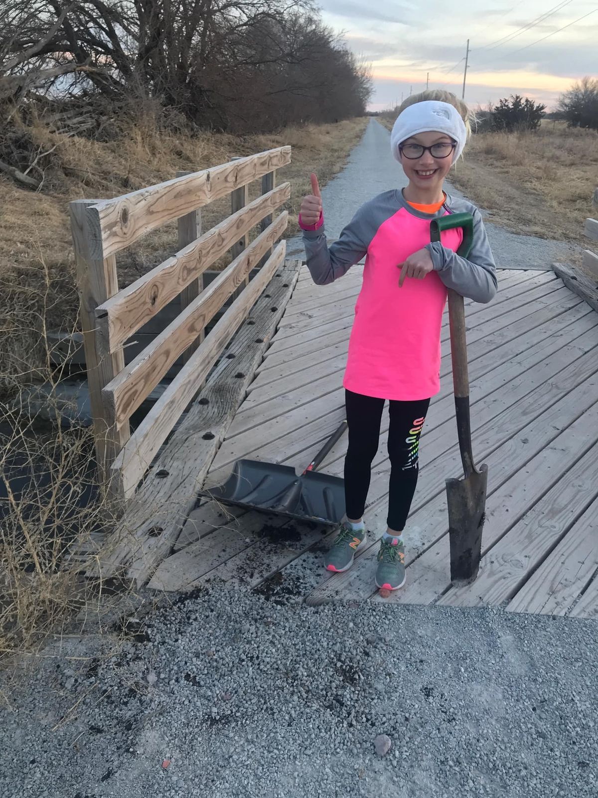 Young volunteer who patched a washed out area of the Dark Island Trail