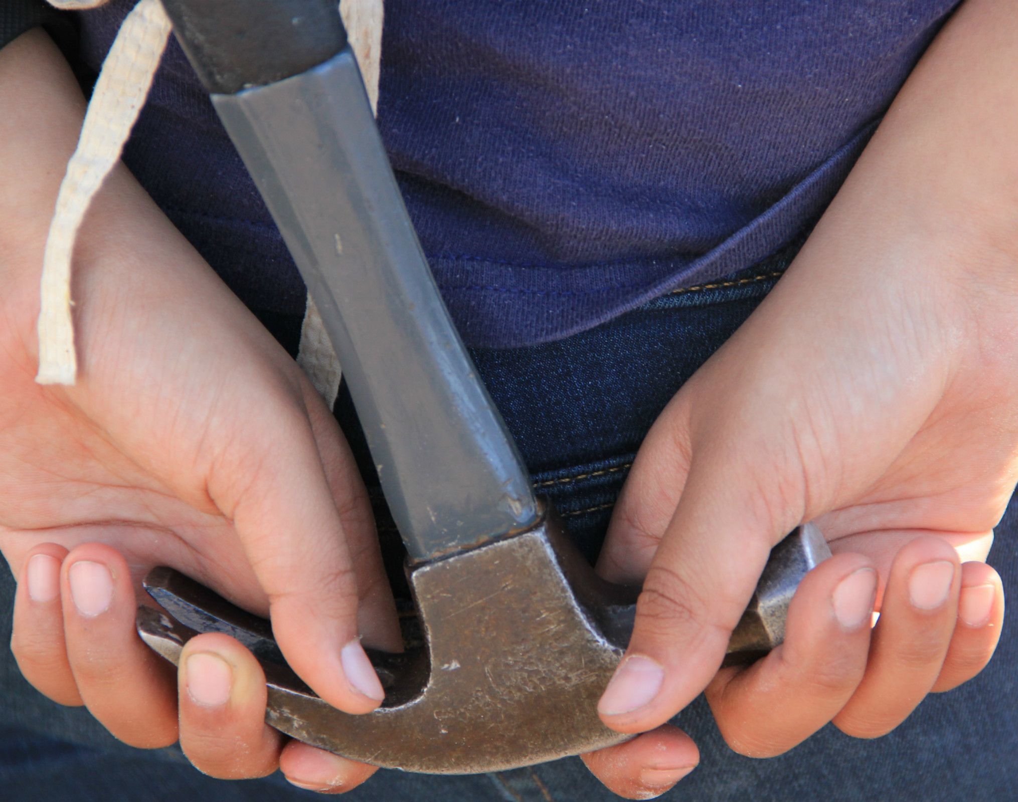 Hands holding hammer ready to work