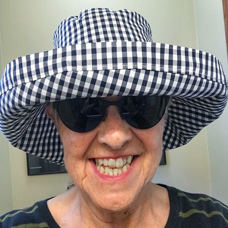 Photo of Judy wearing a black and white check-printed hat.