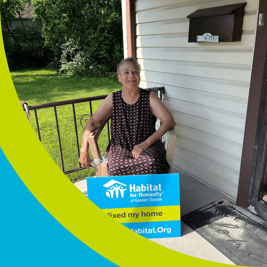 A woman smiling while sitting on the front porch