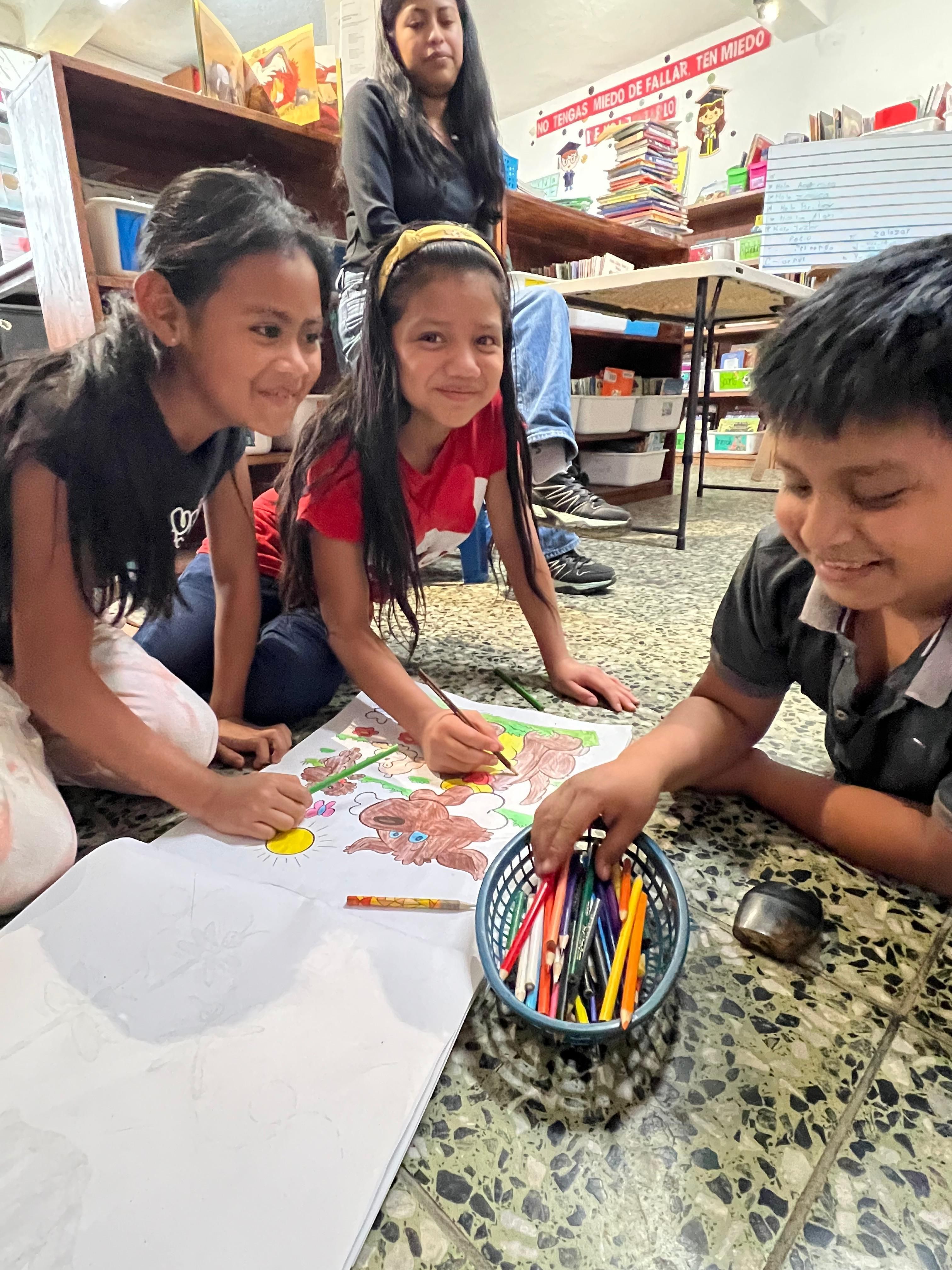 Two young children looking at a picture book.