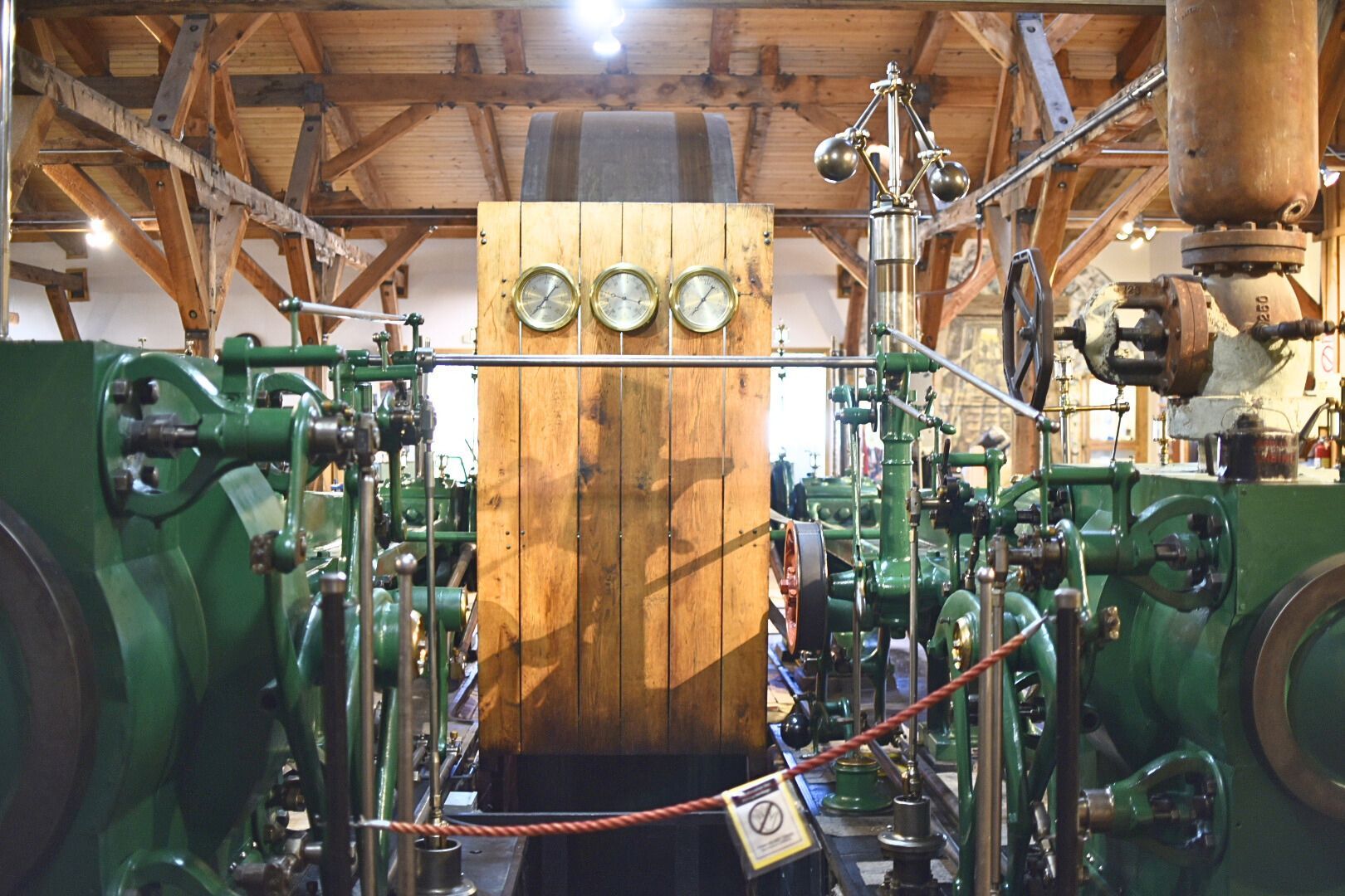 A view of the Corliss Steam Engine showing the flyball governor and pressure gauges.  