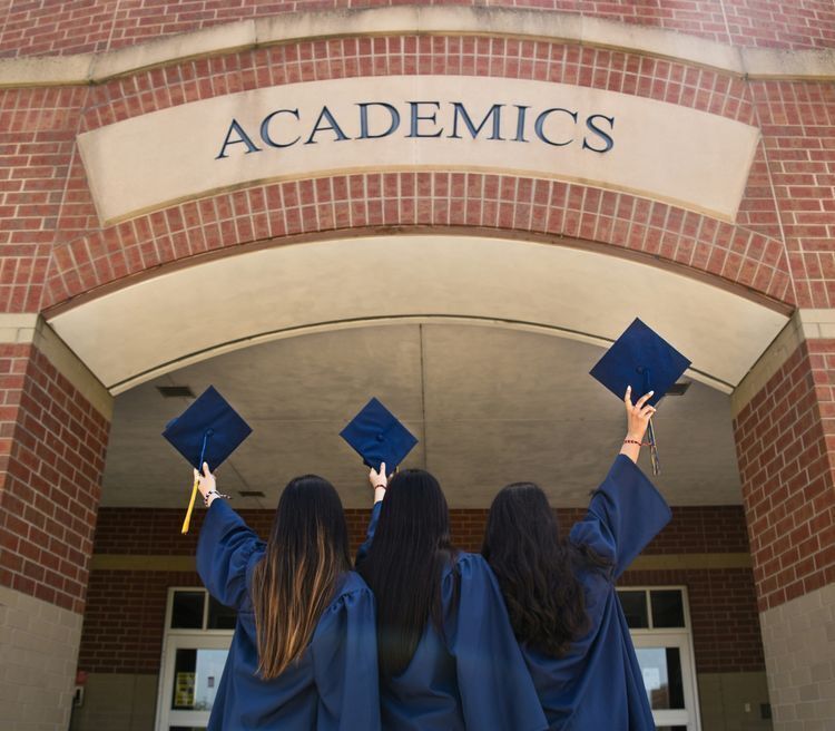 Black graduation cap with blue and yellow tassel.
