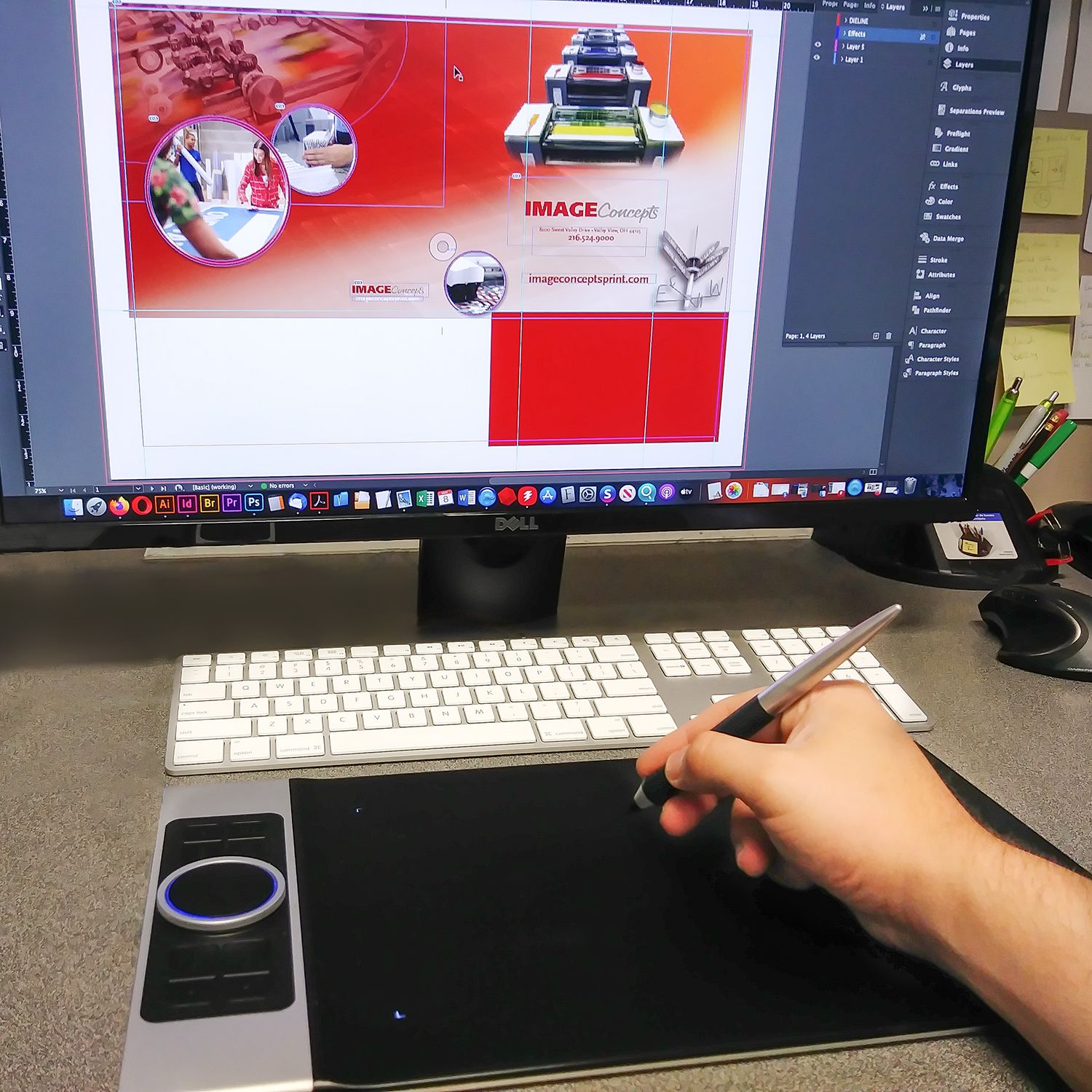 Graphic artist using pen tablet and computer for print design