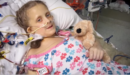 For some pediatric PSC patients, hospital stays are necessary. In this photo, a young gift holds her stuffed dog while being hooked up to wires.