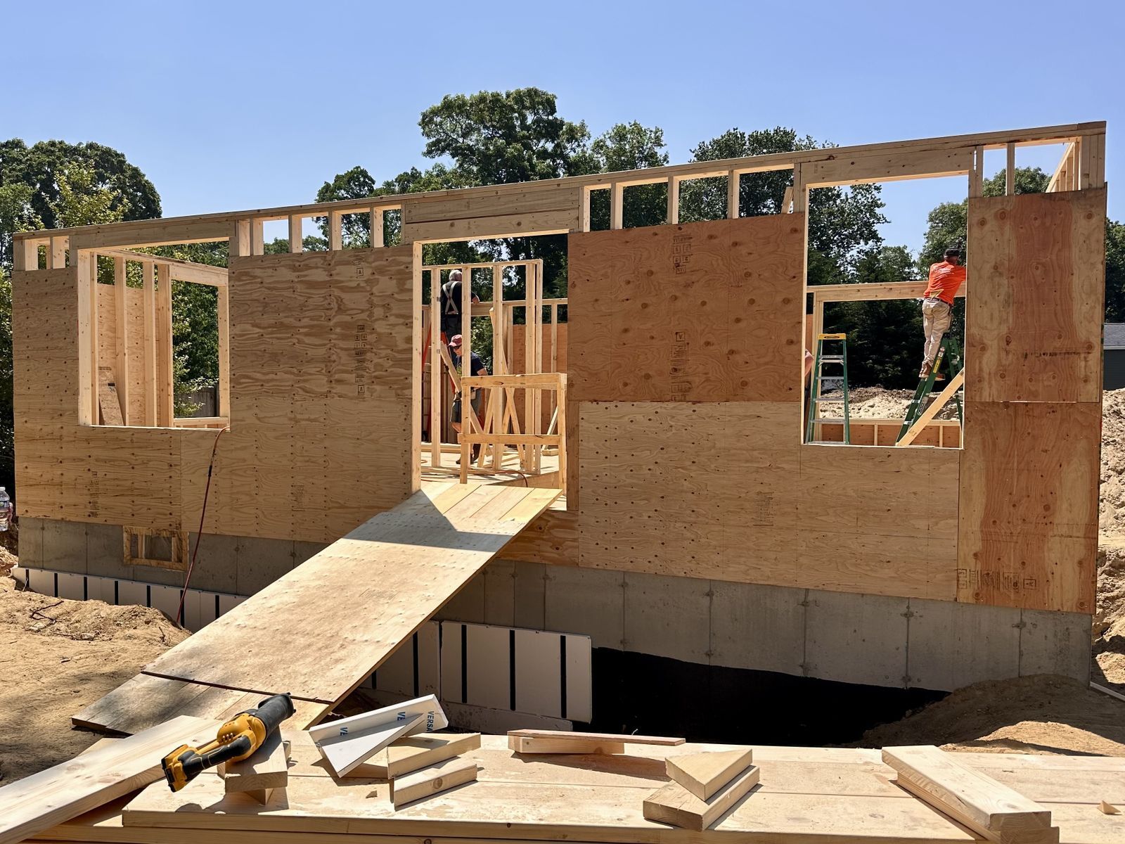 A close up of the framing of a new house with first floor walls built