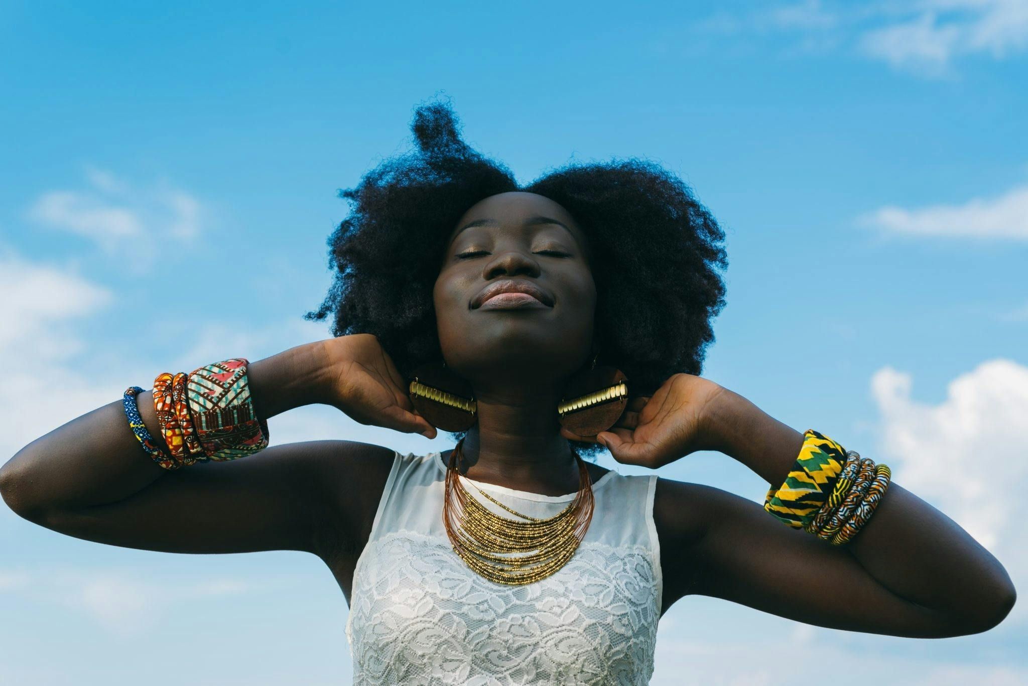 woman with a clear blue sky behind her