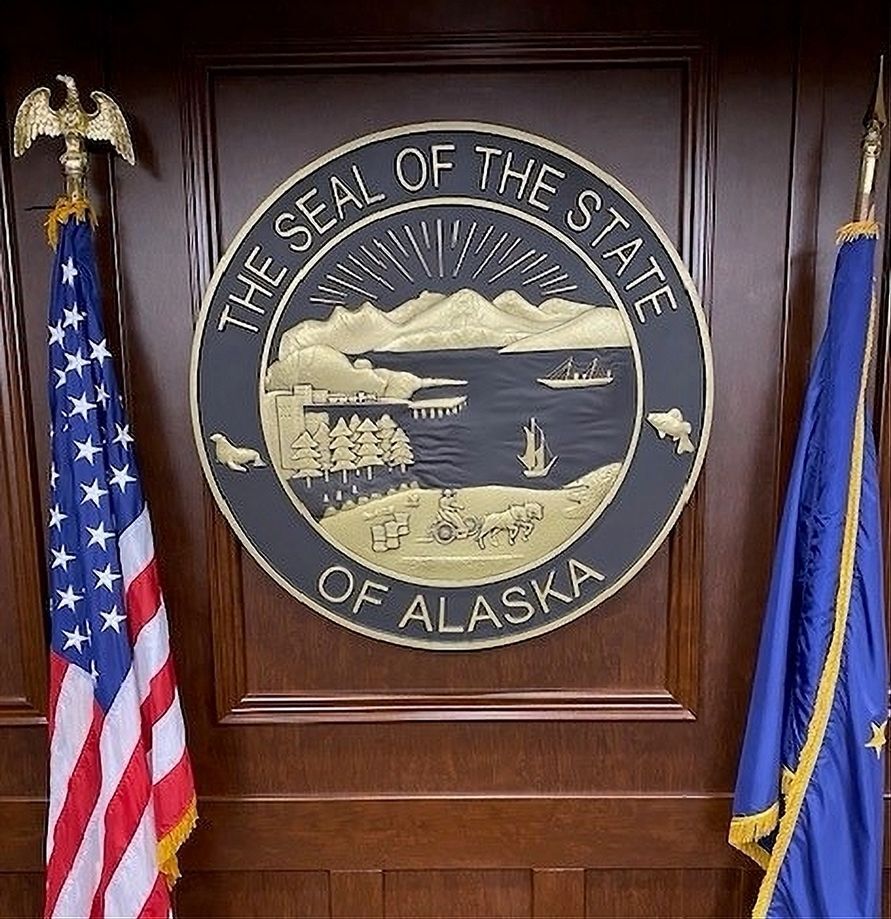 BP-1005A - Carved 3-D Bas-Relief Wall plaque of the Great Seal of the State of Alaska, Mounted between Two Flags