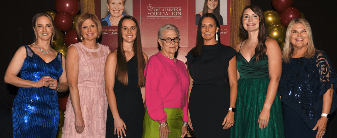 group of women posing for awards ceremony