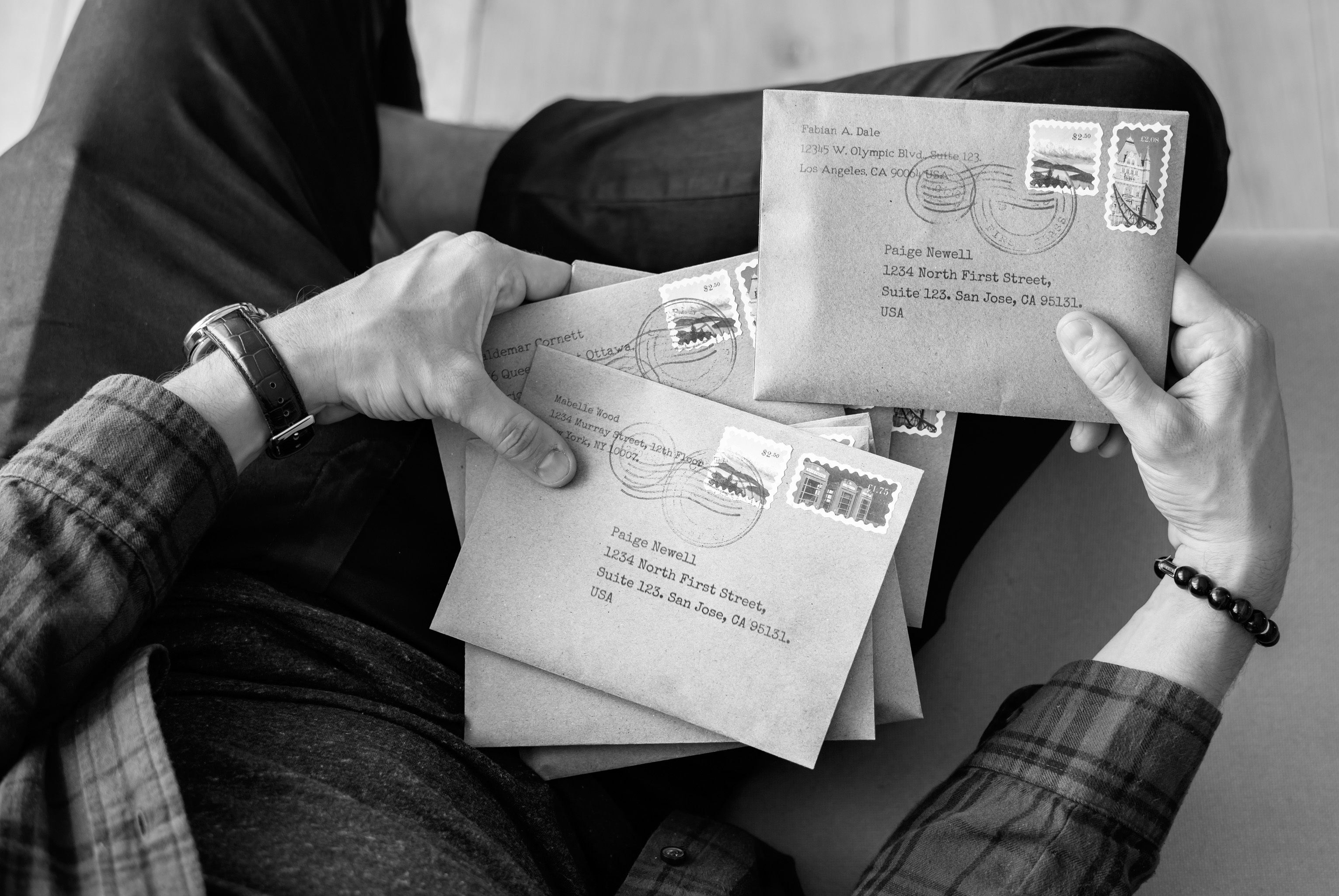 Ways to save on postage. Photo of person holding mail.