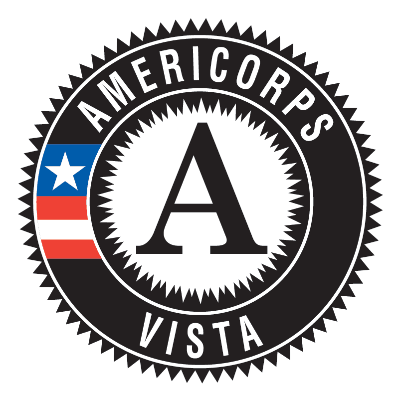 The image is the AmeriCorps VISTA logo, featuring a large "A" in the center surrounded by a black circular seal with the words "AMERICORPS" at the top and "VISTA" at the bottom, along with an American flag element on the left side of the seal.